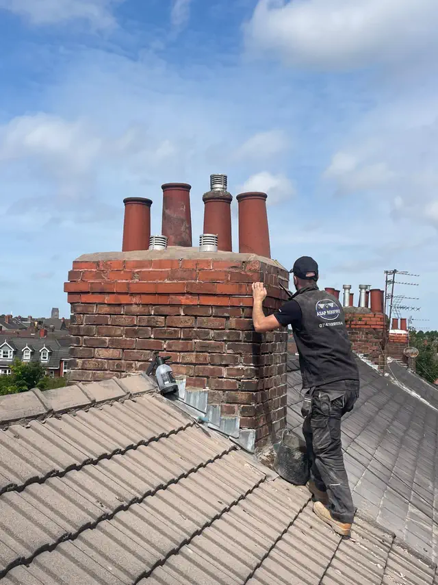 One of the ASAP Roofing team working on a brick chimney stack with four clay pots