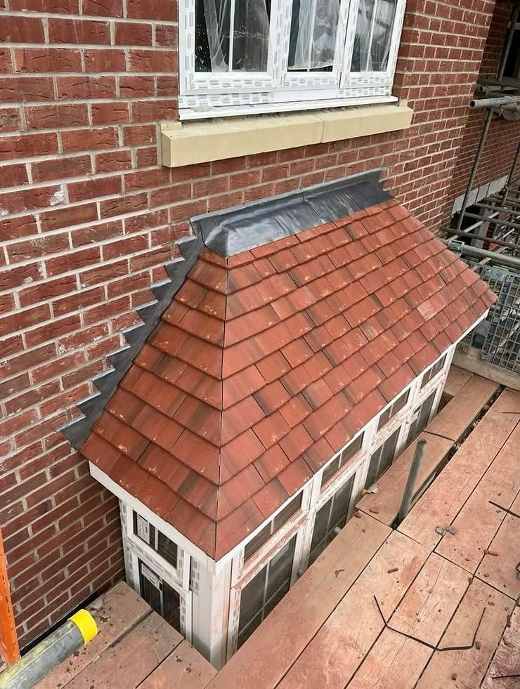 Small bay roof re-tiled in red tiles