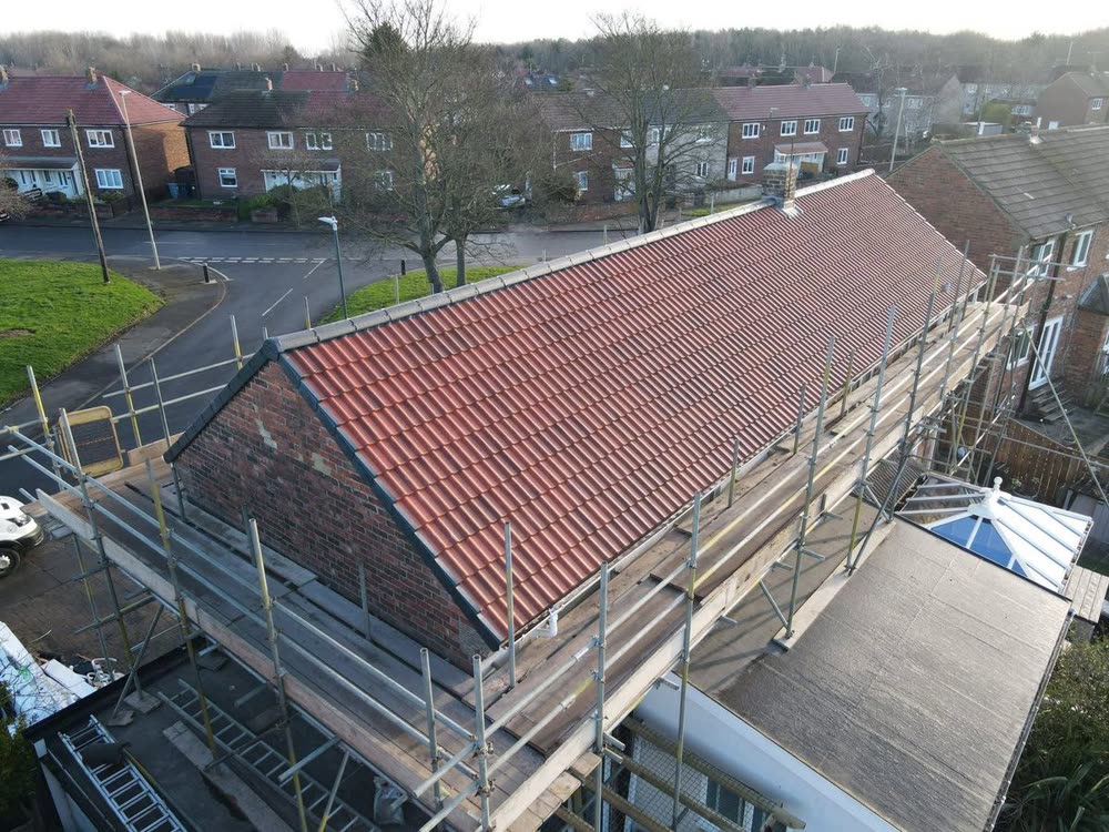 Red tiled roof finished, scaffolding still up